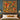 Red Squirrel Hazel Woodland woven blanket design shown without a name as a wall tapestry above a bed