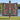 River Birch Cardinal Parade woven blanket held up outdoors by a lake