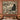 Rosehip Cat Cameos woven blanket hung as a wall tapestry above a bed