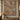 Rust Cream Gossamer Meadow Pattern woven blanket displayed as a wall tapestry above a wooden console on a sage green wall