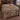 Rust and cream autumn meadow pattern woven blanket spread on a bed