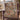Rust Cream Gossamer Meadow Pattern woven blanket draped over a mauve wingback armchair