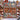 Scandinavian Christmas Gnome Farm woven blanket displayed outdoors in the snow by a red farmhouse