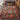 Scandinavian Christmas Mini Scenes woven blanket spread on a bed with red, green and gold pillows