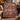 Scandinavian Christmas Mini Scenes woven blanket draped over a green velvet sofa