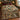 Green and rust north woods pattern woven blanket spread on a bed in a log cabin bedroom
