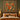 Squirrel Family Hazel Bower woven blanket design shown without a name as a wall tapestry above a bed