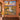 Sunrise Balloon Valley woven blanket displayed as a wall tapestry on a terracotta wall above a wooden console