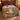 Hot air balloons over a golden river valley woven blanket spread on a bed