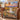 Sunrise Balloon Valley woven blanket draped over a leather armchair
