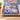 Swallow Iris Ribbon Ballet woven blanket draped over a sofa in a living room