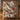 Tufted Titmouse Winter Skimmia quilt hung on a wall above a bench with 2 matching pillowcases