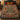 Victorian Christmas Toy Cabinet woven blanket spread on a bed with red and mustard pillows