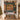 Personalized Victorian Christmas Toy Shop quilt with custom family name hung on a wall above a bench with matching pillowcases