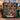 Vintage Christmas Lights photo blanket with seven family photos and a cream name banner on a green velvet armchair