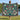Wilderkind Christmas Garden woven blanket held up outdoors by a lake