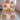 Two little girls holding a personalized Winnie the Pooh pastel Christmas blanket with their names on the pink banner