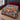 Winter Fox Hellebore woven blanket spread on a bed