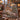 Woodland Christmas Deer Family woven blanket draped over a leather sofa by a stone fireplace