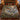 Woodland Christmas Red Deer Crossing woven blanket spread on a bed in a log cabin bedroom