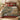 Zinnia Lavoir Village Garden woven blanket spread across a bed in a cozy bedroom